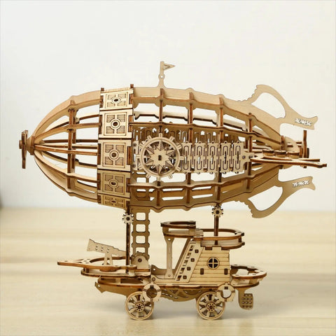 Side view of assembled 3D Wooden Airship Puzzle Kit for adults and teens, 160 pre-cut pieces, natural wood model on table.