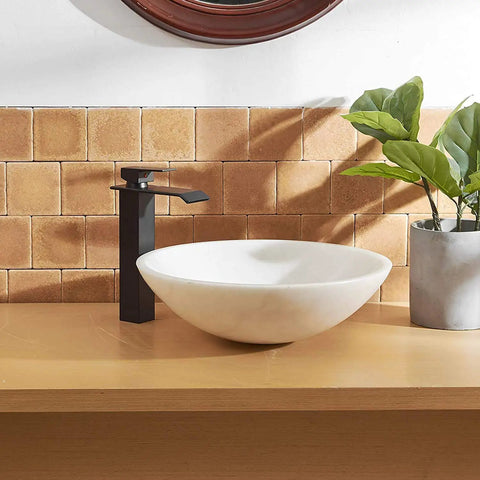 Matte Black Bathroom Vessel Sink Faucet Tall Deck Mount With Pop Up Drain beside a white vessel sink on wood vanity