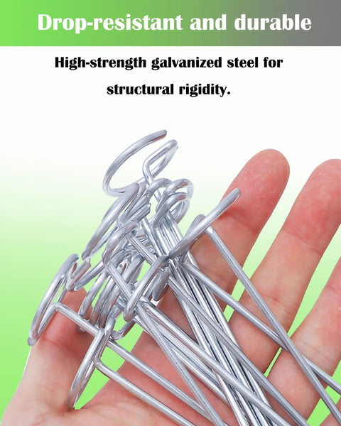 Hand holding pack of 50 landscape staples with pick hook 6 inch galvanized garden pins for weed fabric lawn tent yard and sod