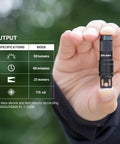 Person holding Mini USB Rechargeable Keychain Flashlight with 50 Lumen Output, specifications displayed beside