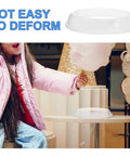 Child enjoying cotton candy next to Cotton Candy Maker Guard Lid Shield for 10 Inch Machine, keeping area safe and mess-free.