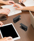 Slick Under Desk Laptop Mount With Adjustable Angle Plastic Shelf used on a desk with tablets and books, showcasing ergonomic setup.