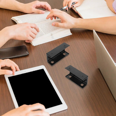 Slick Under Desk Laptop Mount With Adjustable Angle Plastic Shelf used on a desk with tablets and books, showcasing ergonomic setup.