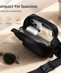 Ultra Compact Crossbody Sling Bag With Water Resistant Dual Pocket Chest Pack For Running Travel And Everyday Workouts displaying open compartments with phone, AirPods, and tissues.