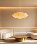 20 Inch Oval Paper Lantern Pendant Light White Rice Paper Ceiling Lamp Japanese Style diffused glow over a modern white sectional sofa.