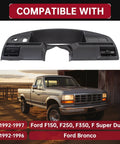 Black plastic dash bezel panel for Ford F-150/F-250/F-350 and Bronco (1992–1997); shown with a pickup in background