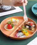 Portion Control 2 Pack 9 Inch Unbreakable Divided Plates With 3 Compartments For Easy Weight Loss And Balanced Meals Reusable Dinner Plates For Adults Black, shown with assorted fruits and desserts.
