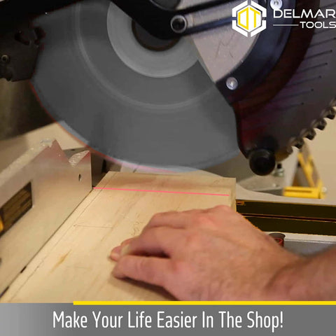 Delmar Tools miter saw with bright red laser guide projecting line onto wood for precise cuts.