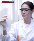 Pacific PPE safety glasses with blue wraparound frame and clear lenses in lab setting.
