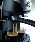 Pro Grade 15 Bar Pump Driven Espresso Maker With Stainless Steel Boiler And Swivel Jet Frother For Creamy Drinks Plus Built In Tamper And Quick Fill Reservoir For Badass Home Baristas brewing espresso into two glass cups.