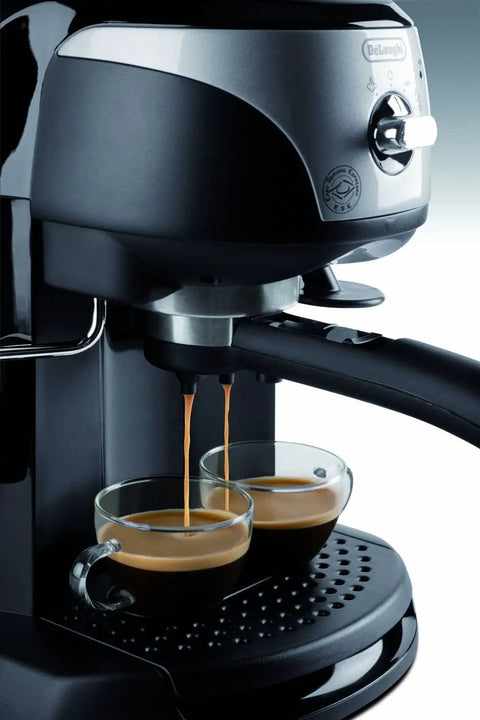 Pro Grade 15 Bar Pump Driven Espresso Maker With Stainless Steel Boiler And Swivel Jet Frother For Creamy Drinks Plus Built In Tamper And Quick Fill Reservoir For Badass Home Baristas brewing espresso into two glass cups.