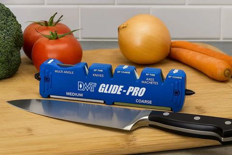 Front view of Glide-Pro All-In-One Multi Tool Blade Sharpener with ceramic stones, diamond sharpening stone, and knife on a counter.