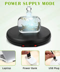 360 Degree Motorized Rotating Display Stand Turntable With Built-In LED Lighting For Jewelry And Photography Products Electric Base USB Powered Smooth Rotation Showpiece Spinner 10 Inch Capacity with decorative bottle on black base.
