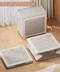 Heavy Duty Foldable Storage Bin With Lid Gray Extra Large 120L Capacity Wheels Smooth Glide For Closet Bedroom Living Room viewed from above with lid open and partially folded