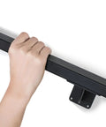 Hand gripping a Heavy Duty 24 Inch Steel Stair Handrail Wall Mount Square Pipe Grab Bar For Indoor Outdoor Steps Deck Porch.