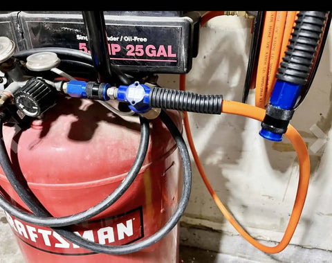 Top Shelf Aluminum Air Hose Fittings Kit Featuring Quick Connect Coupler And Industrial Air Plug One Hand Operation Rock Solid Six Ball Lock Design 1/4 Inch Blue Compressor Gear attached to air compressor.