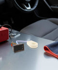 Compact Digital DC Volt And Amp Meter With Hall Effect Sensor Dual LED Display For Cars Boats And Rv on car dashboard with a towel.