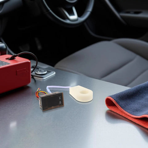 Compact Digital DC Volt And Amp Meter With Hall Effect Sensor Dual LED Display For Cars Boats And Rv on car dashboard with a towel.
