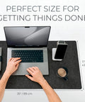 Large Felt Desk Mat 35 x 17 Inch Charcoal With Seamless Design And Anti Slip Rubber Dots Full Keyboard And Mouse Pad For Desktop Computer Workstation Leather Logo Tab in use with laptop and phone.