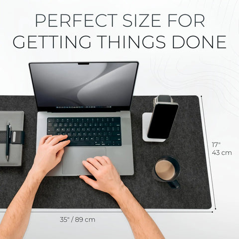 Large Felt Desk Mat 35 x 17 Inch Charcoal With Seamless Design And Anti Slip Rubber Dots Full Keyboard And Mouse Pad For Desktop Computer Workstation Leather Logo Tab in use with laptop and phone.