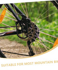 Rear Derailleur Guard And Rack Protector For Mountain Road And Folding Bikes In Black, mounted on a bike wheel, outdoors
