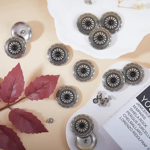 Knockout Vintage Screw Back Buttons 30mm Round Conchos Black Artificial Turquoise on a surface with decorative leaves.