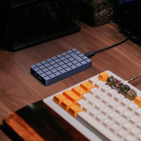 No Sweat M2 NVMe SSD Enclosure Rugged Aluminum USB4 External Drive Case on wooden desk next to keyboard.