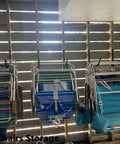8 Pack Heavy Duty Wall Mounted Ladder Hooks With 12 Inch Jumbo Arm holding folded chairs in a wooden shed
