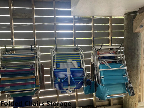 8 Pack Heavy Duty Wall Mounted Ladder Hooks With 12 Inch Jumbo Arm holding folded chairs in a wooden shed