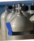 Neoprene Scuba Tank Belt With Secure Hold For Dive Gear, shown securing tanks with blue strap on beach, ensuring secure hold.