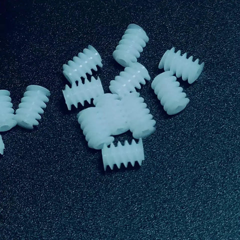 10 Pack 0.3 Module Plastic Mini Worm Gears Kit, 0.65mm Inner Hole, 3.5 By 5mm Size, scattered on dark surface