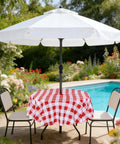 Round 60 Inch Outdoor Tablecloth With Umbrella Hole And Zipper, red and white gingham, spill proof, on patio table by pool
