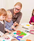 Adults and children using the 12 Piece Multicolor Single Hole Puncher Set, Quarter Inch Metal Handheld Circle Punch With Soft Grip for crafts.