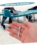 Hand holding metal peg with Heavy Duty Metal Turf Spikes Aerator Shoes For Lawn Care in background, Easy Install Aerating Pegs visible