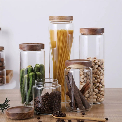 Straight Up Solid Airtight Coffee And Tea Storage Canister With Smooth Wood Lid Absolute Badass Upgrade For Your Countertop This Food Grade Sealed Jar displaying various food items in glass jars.