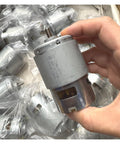 RS-775WC-A010 High Octane Carbon Brush DC Motor 21000 RPM 14.4V in hand, showcasing direct drive motor design.