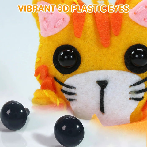 Close-up of vibrant 3D plastic eyes on cat felt project from Cat Sewing Kit For Kids Beginners Starter Kit With Pre-Punched Felt Learn To Sew For Ages 6 To 12 Includes Five Kitten Projects Colorful Threads Safe Felt Pieces Totally DIY Gift For Girls And Boys.