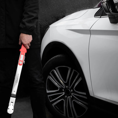 Person holding Flex Head Split Beam Torque Wrench With Easy Knob Dial Heavy Duty Clockwise Torque next to car wheel