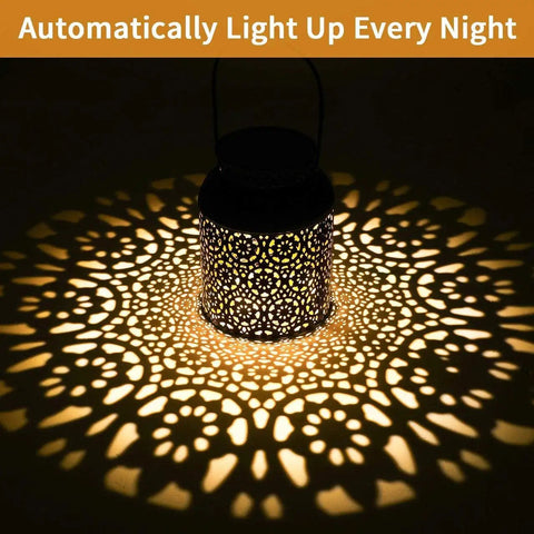 Outdoor Solar Lanterns Pack of 2 Waterproof Hanging Lanterns with handles casting decorative light patterns at night.