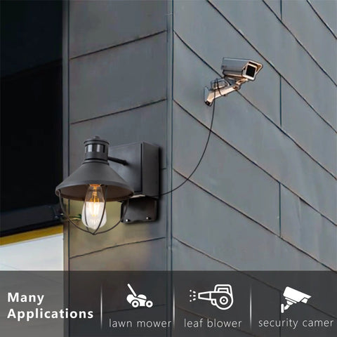 Outdoor Wall Light With GFCI Outlet, 2 Pack, Motion Sensor, mounted on exterior wall next to security camera.