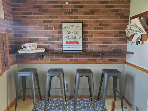 Heavy Duty Folding Shelf Brackets 16 Inch Stainless Steel Supports Collapsible Shelf Bracket For Table And Work Bench 330 Lb Max Load Space Saving DIY Bracket Pack Of 2 under wooden shelf in brick wall kitchen setting with stools.