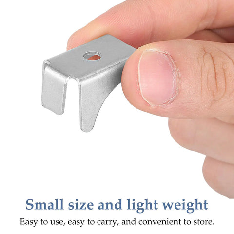 Close-up of Heavy Duty Steel Cabinet Shelf Clips Set Of 10, silver metal clip held between fingers, showing small size.
