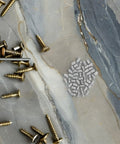 Upgrade Your Home With These 50pcs Stainless Steel Cylindrical Dowel Pins image on stone surface, showing smooth finish and various screws.