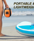 Person holding Electric Portable Paddle Board Pump For SUP with Auto Off and 20 PSI Beast Power Air Compressor on the beach.