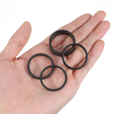 Hand holding 12Pcs Aluminum Headset Spacers For 1 1 8 Inch Stems 4 Thicknesses 2mm 3mm 5mm 10mm Black Stem Spacers