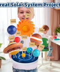 Child holding Hands On Solar System Project Kit For Kids Ages 3 To 5 With Foam Planets and Sun and Stars in a classroom
