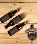 Badass 2 Pack Wall Mounted Beer Bottle Opener, Rustic Heavy Duty Metal For Bars And Game Rooms, Comes With All Screws For Straight Up Easy Setup, Smooth Twists Make Opening Bottles A Cinch with dark beer bottles on wooden surface.