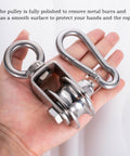 Hand holding stainless steel Beefy Two Pack Heavy Duty Cable Pulley Block Wheels with Clip for Wire Rope Ball Bearings DIY Gym Pulley System for Home Workouts Winch and Lifting Setup Kit.