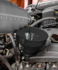 Hand pouring oil into engine using Five Piece Auto Oil Funnel Set With Flexible Neck And Filter Screen For Gas Oil Coolant And Engine Oil