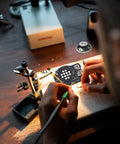 Hands assembling AM FM Radio Kit For Learning And Practice A Hands On Soldering Project That Teaches Electronics on a workbench.